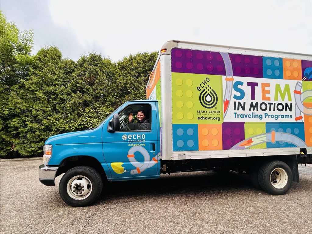 ECHO educator waving from the STEM in Motion Education truck