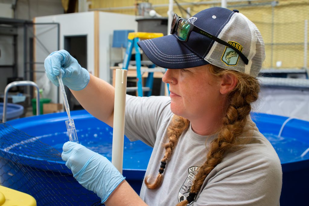 ECHO Animal Care specialist Olivia testing water samples at ECHO's offsite aquatic facility.