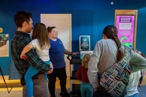 Image of ECHO Animal Care specialist Nicole speaking to a group of guests outside ECHO's Into the Lake exhibit, which is currently closed for renovation.